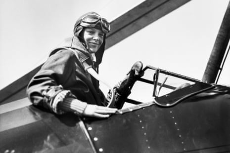 Amelia Earhart smiles in the cockpit of her autogiro, wearing a flying helmet and goggles