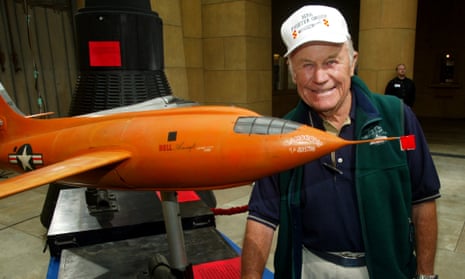 Chuck Yeager, the first pilot to break the sound barrier in the Bell X-1, poses next to a model of the plane.