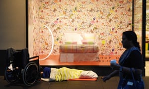 A homeless man sleeps in front of a shop front in Sydney.