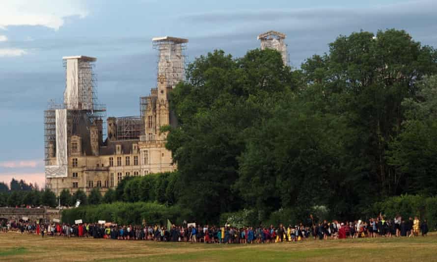 Some of the 30,000 Scouts Unitaires de France leave their camp after taking shelter in the Chateau de Chambord during the storm