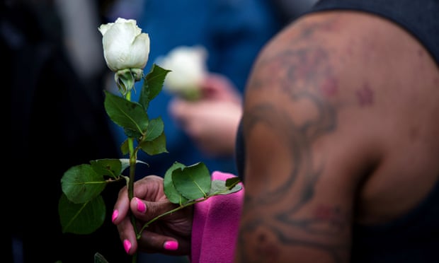 A trans rights activist holds a white rose while protesting against the recent killings of three transgender women during a rally in New York City on 24 May 2019. 