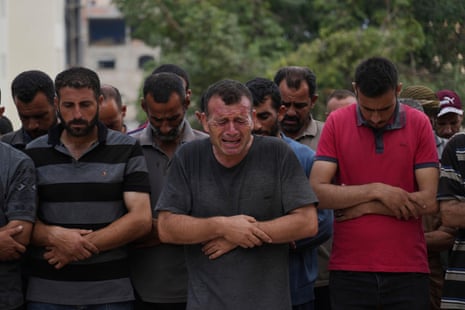 Palestinians pray over the body of a person who was killed while trying to reach aid trucks entering northern Gaza through the Zikim crossing with Israel, at Shifa Hospital, in Gaza City, Saturday, July 26, 2025.