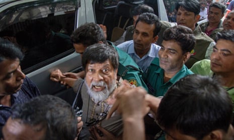 Police escort the photographer Shahidul Alam outside the chief metropolitan magistrate court in Dhaka