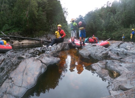 A group of rafters sitting on some rocks on the Franklin river in Tasmania.