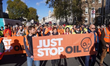 People hold up a just stop oil banner
