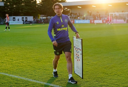 Brentford manager Thomas Frank carrying a tactics board at half-time during a friendly match against Boreham Wood