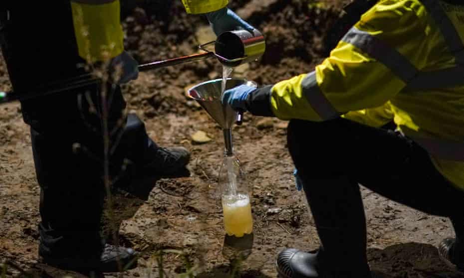 Environment Agency workers take a sample