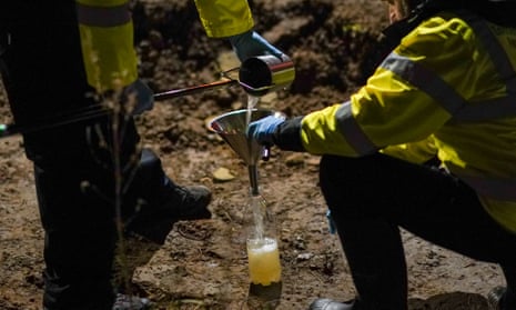 Members of the Environment Agency take a water sample after a ruptured pipe leaked sewage in Saltburn-by-the-Sea in February 2022.
