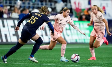 Angel City FC defender Gisele Thompson dribbles away Seattle Reign defender Shae Holmes (25) during the second half of an NWSL soccer match.