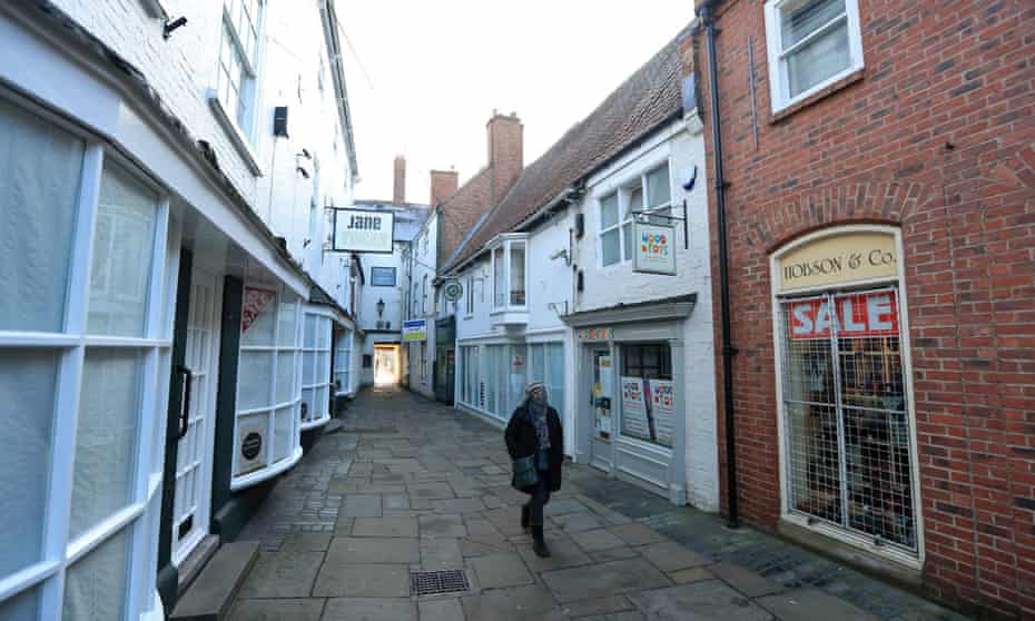  A person walks down a quiet street during lockdown in Newark-on-Trent in Nottinghamshire.
