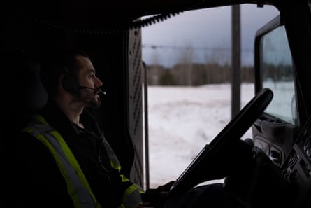 Andy Rae smokes in his truck in Pickle Lake, while getting road updates before heading out.