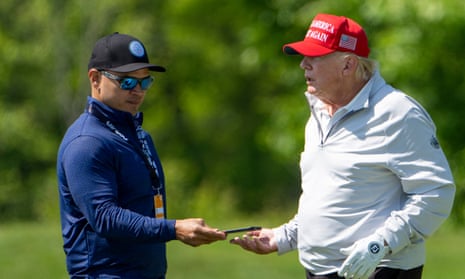 Donald Trump (right) on the golf course with his valet and co-defendant, Walt Nauta