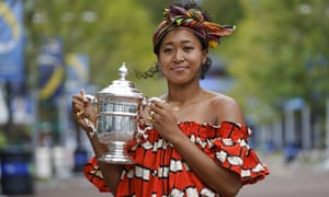 Naomi Osaka holds up the US Open trophy the day after winning the final.