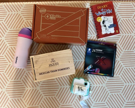 Gifts for nine-year-olds, including a drink bottle, dominoes, a craft kit, a book and pencils