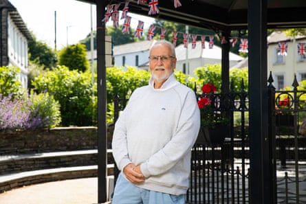 Rob Rotchell stands beside what looks to be a bandstand with union jack bunting around the top of it