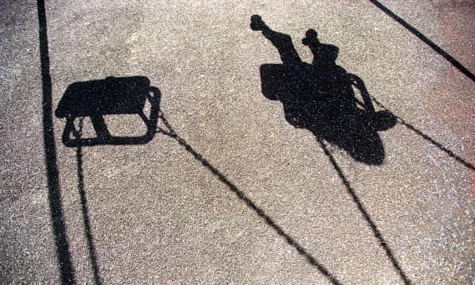 The shadow of a young girl or boy playing on a swingA95CDB The shadow of a young girl or boy playing on a swing