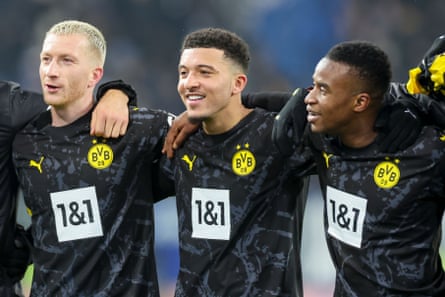 Youssoufa Moukoko and Jadon Sancho line up with Borussia Dortmund’s veteran Marco Reus in 2024.