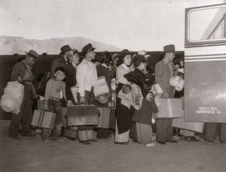 long line of people getting on a bus