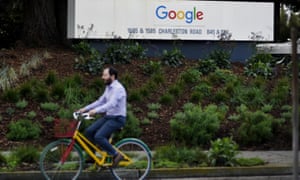 A man cycles past Google campus in San Francisco