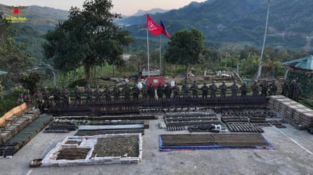 Arakan Army fighters pose with confiscated arms, ammunition and military devices.