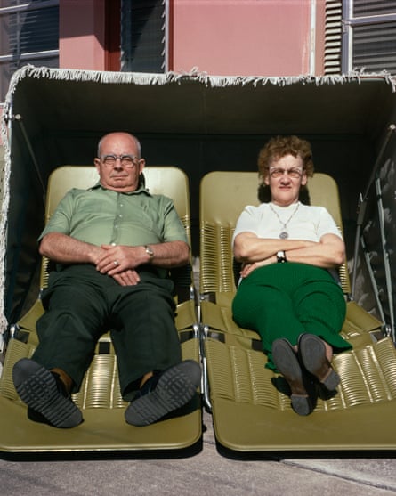 An old couple lying in sun loungers looking at the photographer