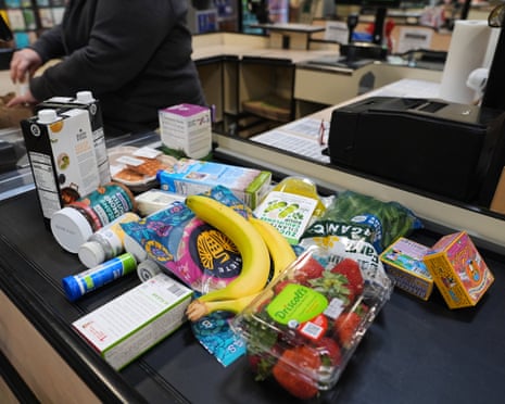 groceries on a conveyor belt at checkout