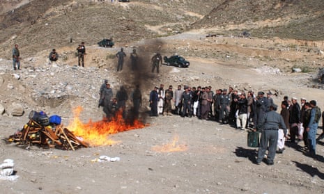 Police officers set seized drugs on fire in Asadabad, Afghanistan