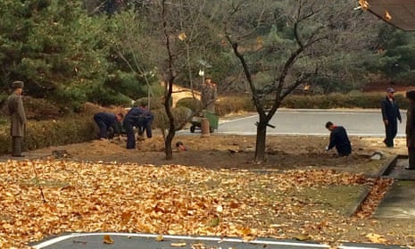 North Korean soldiers dig a trench and plant trees in the area where a defector ran across the border at the Demilitarized Zone (DMZ).