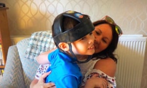 Joanne Griffiths and son Ben, wearing a protective helmet.