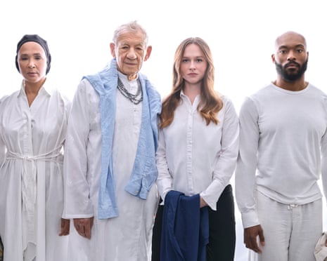 four people in white clothing stand together