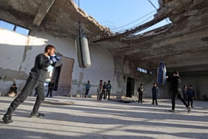 Youths take part in a boxing workout held by local boxer Ahmad Dwara inside a damaged building in the town of Atareb in the rebel-held western countryside of Aleppo.