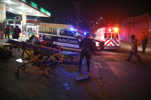 Police and emergency workers descend on a petrol station in Tijuana last month after a drive-by shooting left four men injured