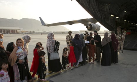 Afghan women and children prepare to be evacuated aboard a Qatari transport plane, at Hamid Karzai International Airport, Afghanistan, 18 August, 2021.