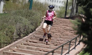 A woman outside the capitol in Denver. Breathing harder may release more virus into the air.
