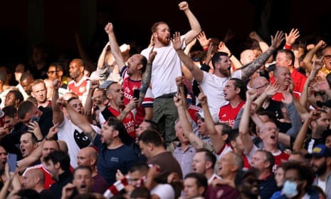 HappyArsenal fans in the stands celebrate the win.