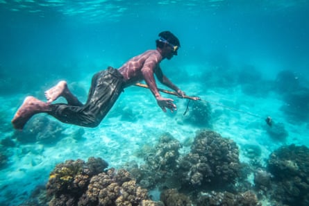 A Bajau boy fishing with a spear.