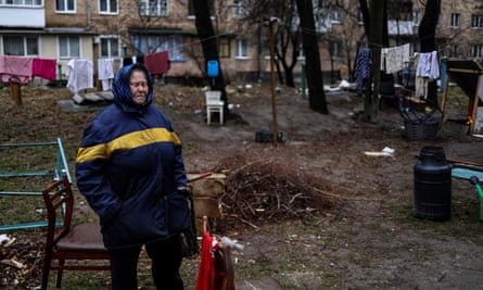 An elderly woman cries near her house in Bucha, northwest of Kyiv, on 2 April 2022, where town’s mayor said 280 people had been buried in a mass grave and that the town is littered with corpses.