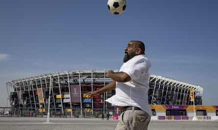 A fan playing football outside the stadium ahead of the FIFA World Cup Qatar 2022