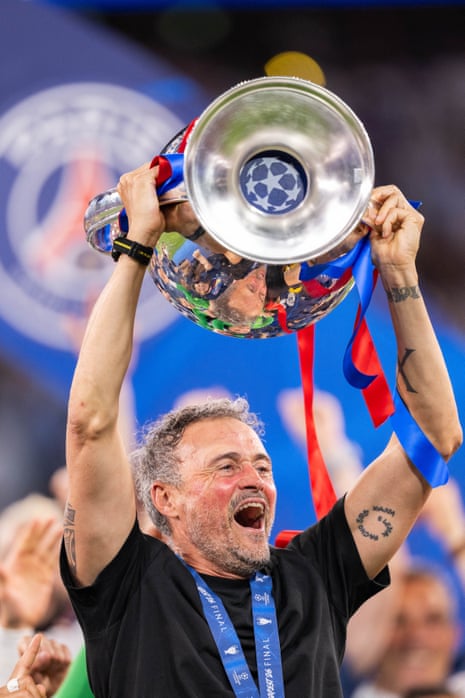 Paris Saint-Germain head coach Luis Enrique lifts the trophy