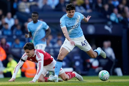 Arsenal’s Kai Havertz goes down under a challenge from Manchester City’s Abdukodir Khusanov on Sunday 19 April