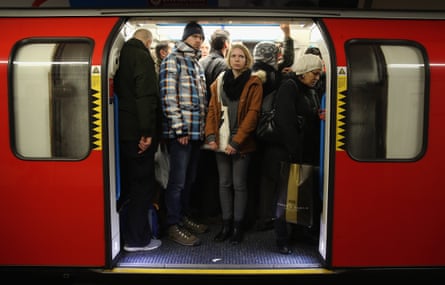 Commuters on a tube at Oxford Street station.