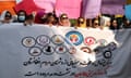 Afghan women in Islamabad hold up posters and placards in a protest demanding to boycott meeting with Taliban in Doha.