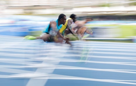 Oscar Smith of Barbados (near) in a heat of the men's 110m hurdles in the first session of athletics at the Scotstoun Stadium.
