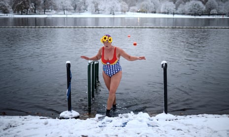 A swimmer dips her feet into the Serpentine Lake in London