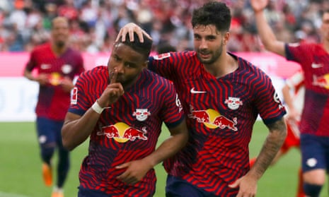 Christopher Nkunku (left) celebrates after his penalty gives RB Leipzig the lead against Bayern Munich