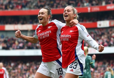 Arsenal's Alessia Russo and Caitlin Foord celebrate a goal against Tottenham Hotspur.