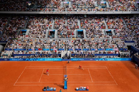 Tennis players on court during match.