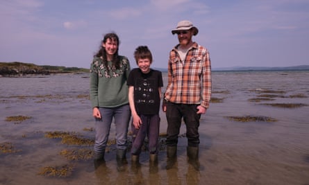 Tony and Catriona Walker on the beach of the island of Gigha with their son, Archie