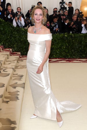 Uma Thurman wore an ivory off-the-shoulder gown by Gabriela Hearst, keeping to the theme with her accessories – a pendant necklace and matching earrings featuring religious symbols