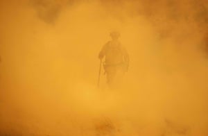 Lakeport, California: A firefighter walks through smoke during the Mendocino Complex fire